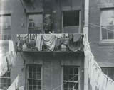 Typical tenement fire-escape serving as an extention of the flat: Allen Street