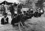 Vietnamese soldiers guard VC prisoners, 11/62