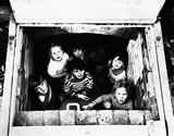 Children peer from bomb shelter