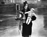 Mother holds child and gas mask
