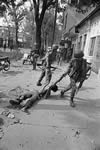 Soldiers drag away a dead VC soldier in Saigon