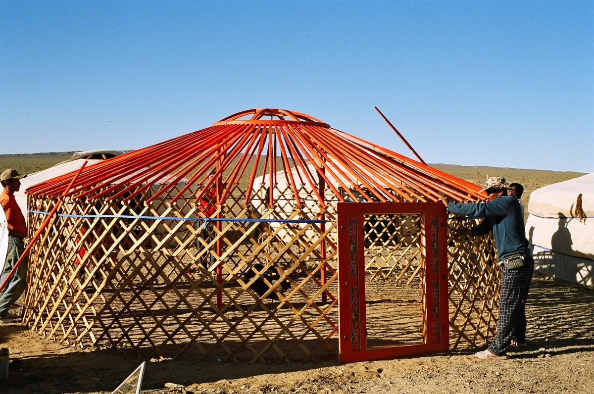 Construction of a ger; note the lattice walls and the roof poles. Later the walls and roof are covered with thick felt to make a waterproof dwelling